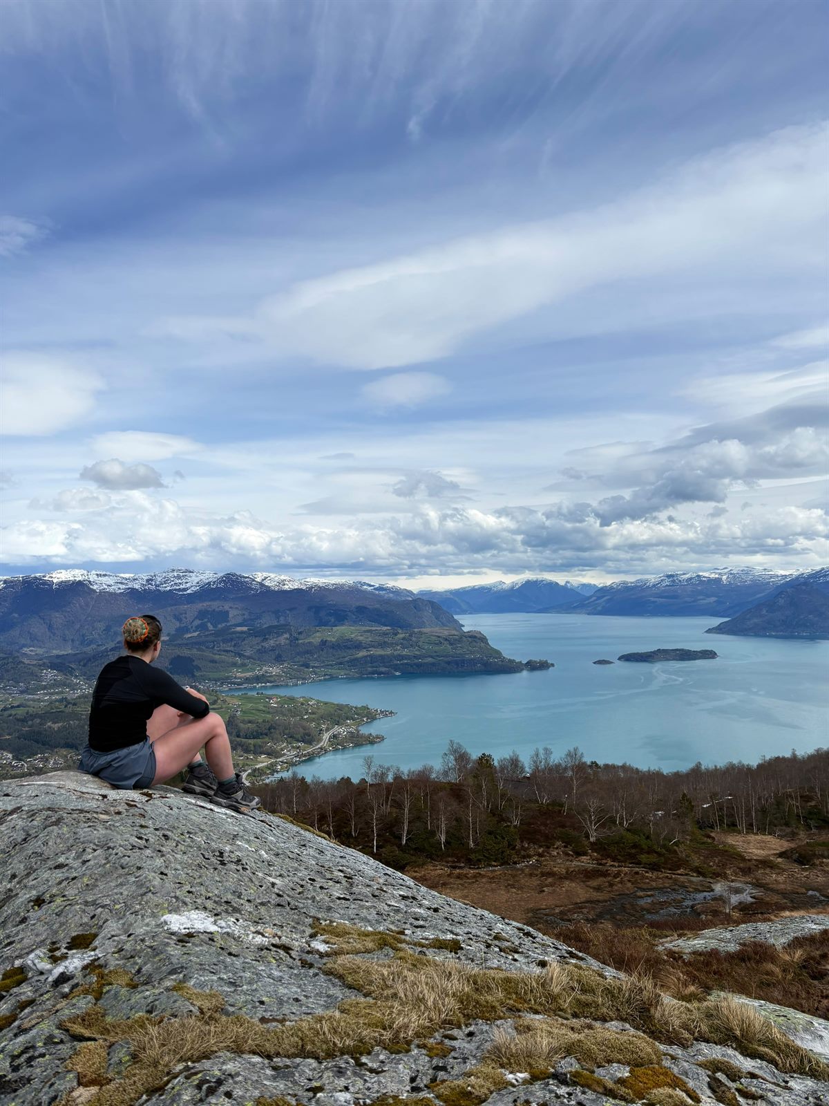 Georgia looking out over a Norwegian fjord from a mountain summit