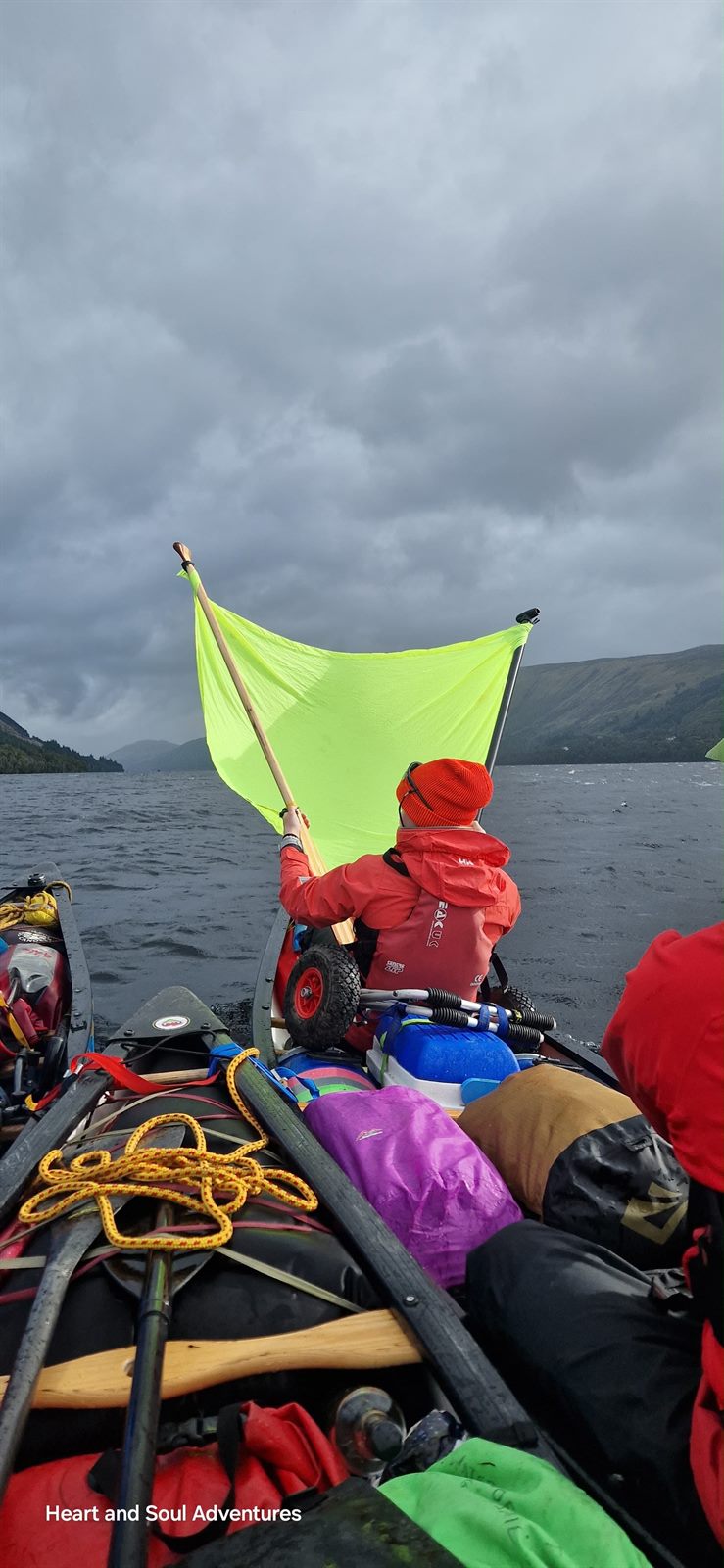 Georgia holding a signal flag on a multi-day canoe expedition