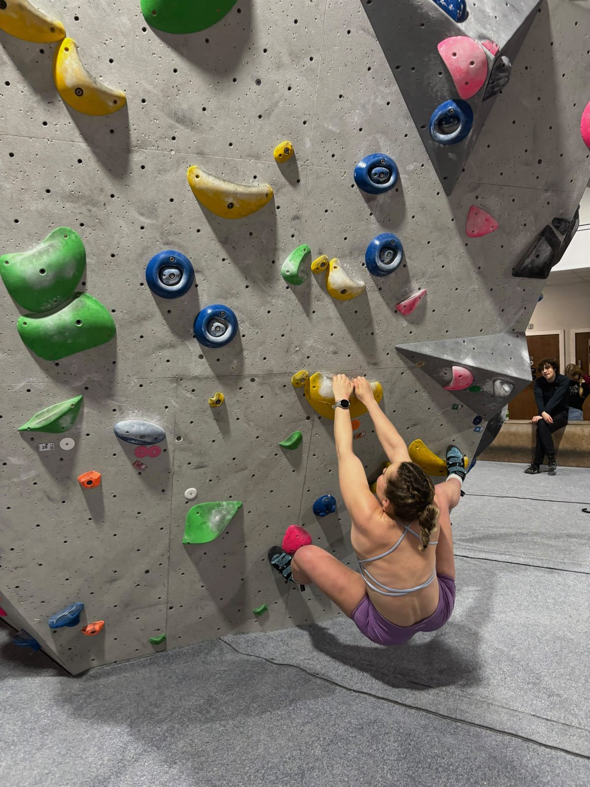 Georgia bouldering on an indoor climbing wall