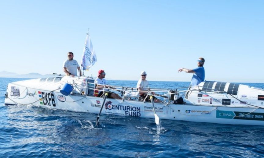 A four-person crew rowing mid-Atlantic